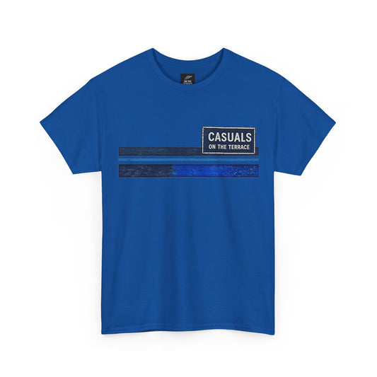 A royal blue short-sleeve t-shirt with a graphic print on the chest. The graphic features a black rectangular box with white text reading 'CASUALS ON THE TERRACE' above two horizontal stripes, one solid dark blue and one textured dark blue.