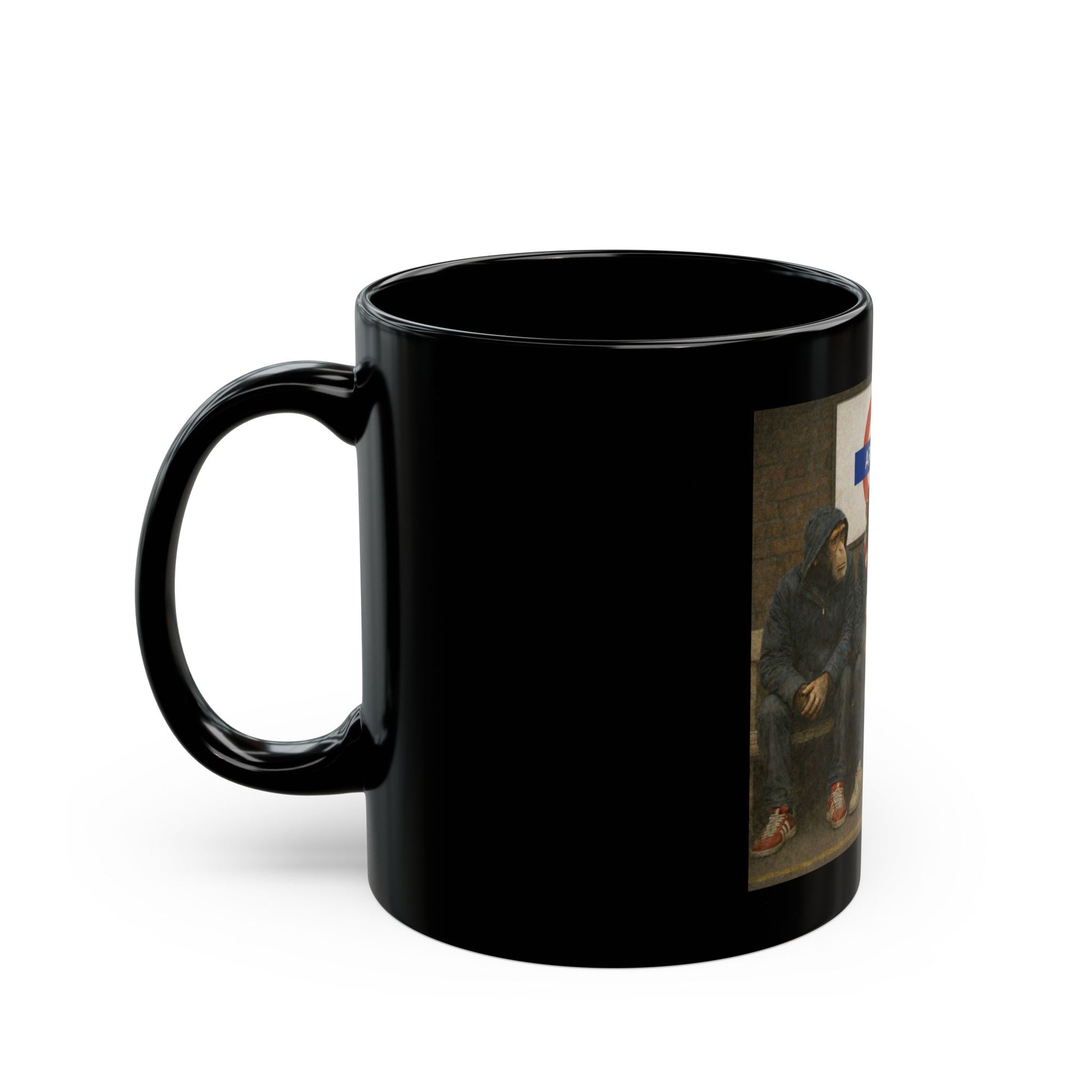 A black ceramic coffee mug featuring a detailed graphic print from On The Terrace showing three chimpanzees dressed as football casuals in retro trainers and red-and-white striped scarves, sitting on a London Underground bench under an Arsenal tube station sign.