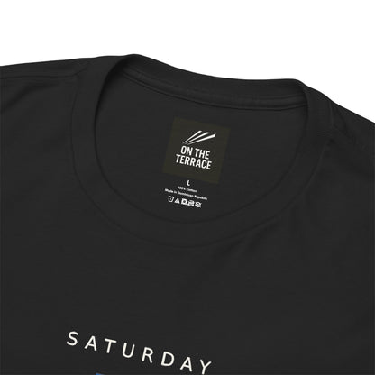 Close-up of On The Terrace neck label and SATURDAY lettering on black tee