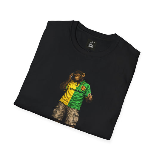 Black folded MUFC -inspired t-shirt featuring a graphic of a chimpanzee in a vintage yellow and green Sharp away kit, smoking and using a mobile phone.