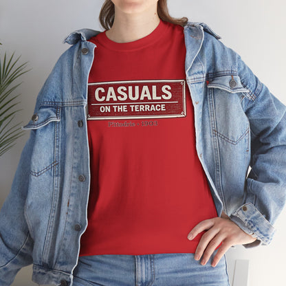 Person wearing a red heavy cotton Aberdeen t-shirt flat lay featuring a central vintage red and white street sign graphic reading "CASUALS ON THE TERRACE" with "Pittodrie • 1903" printed below, and an inner neck label for On The Terrace. and a denim jacket.