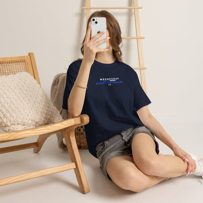 Woman sitting on the floor wearing navy Wednesday Every Saturday Sheffield Wednesday tee