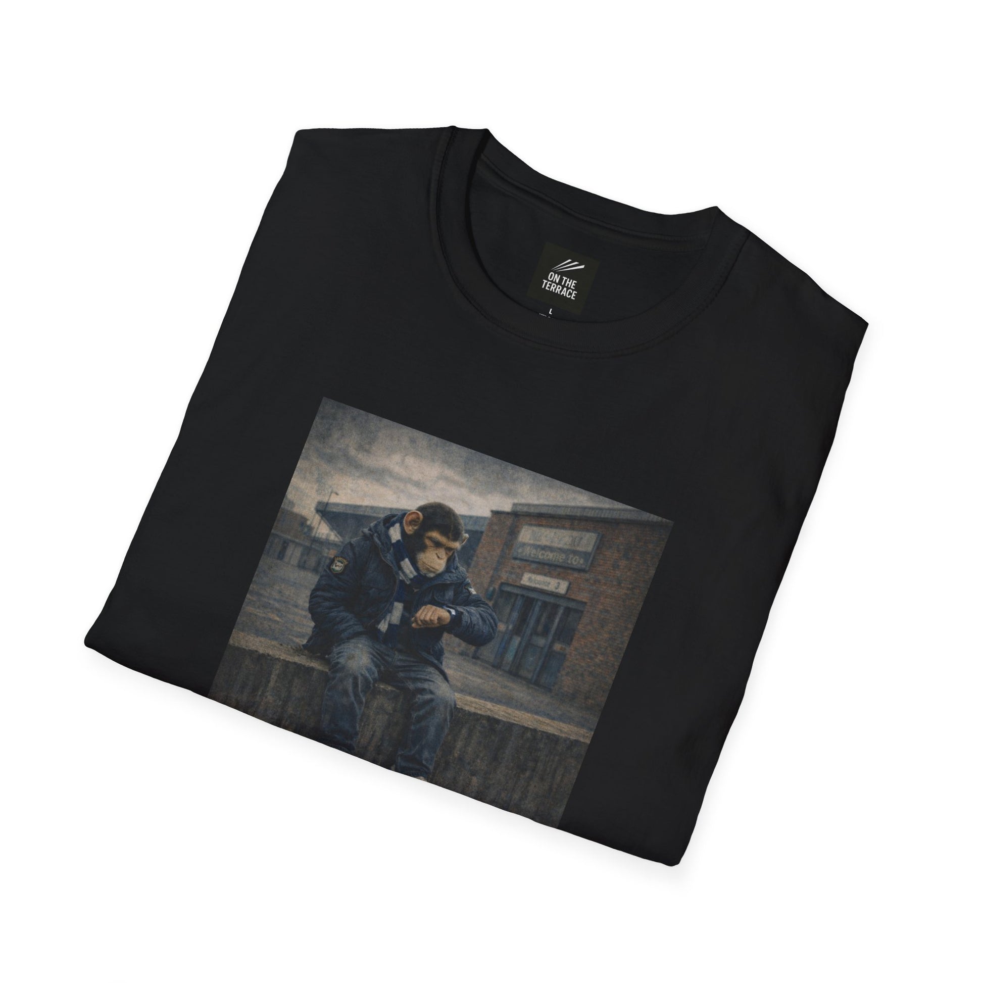 Folded black t-shirt with a graphic of a person sitting on a bench.