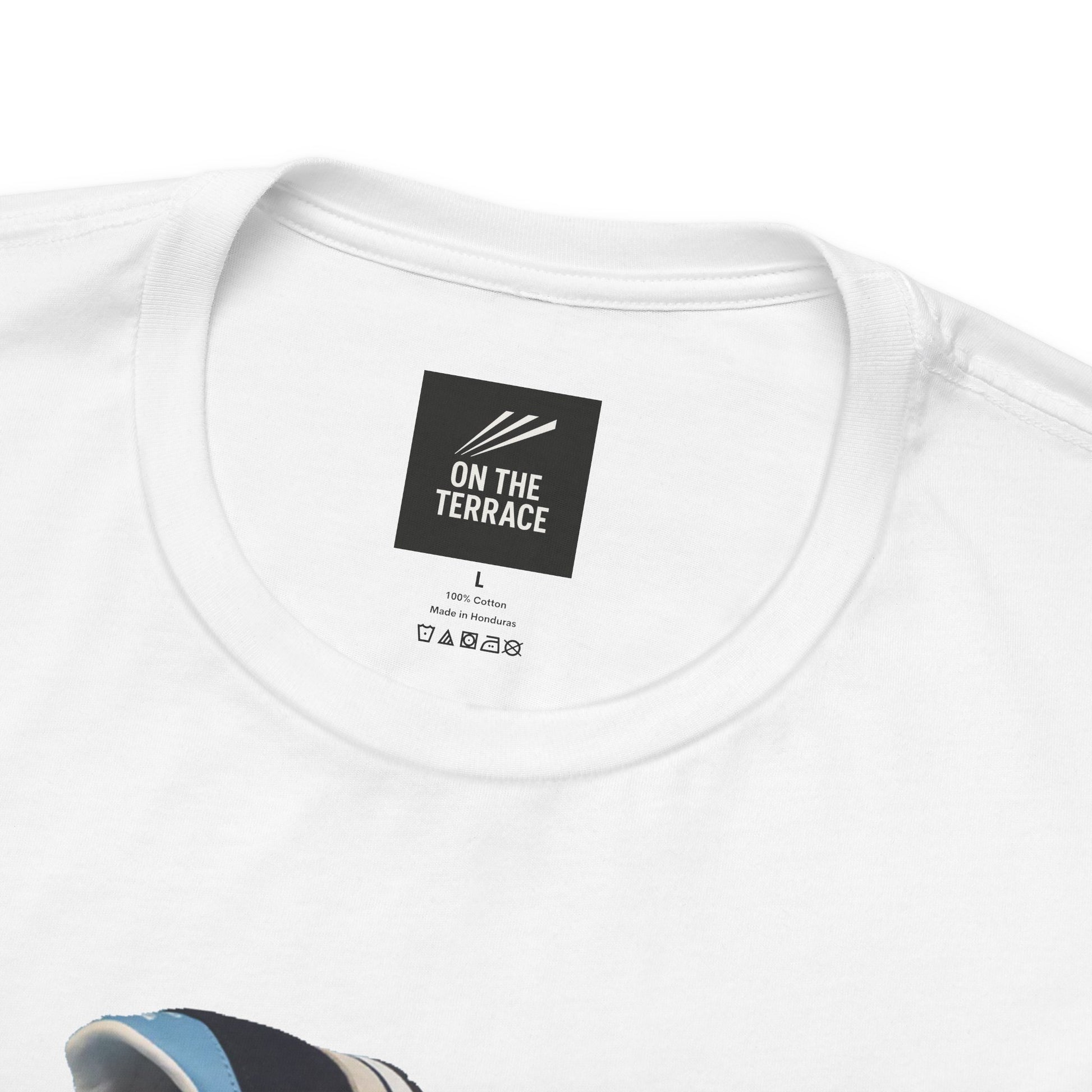 White cotton t-shirt neck label with On The Terrace logo and size large, made in Honduras