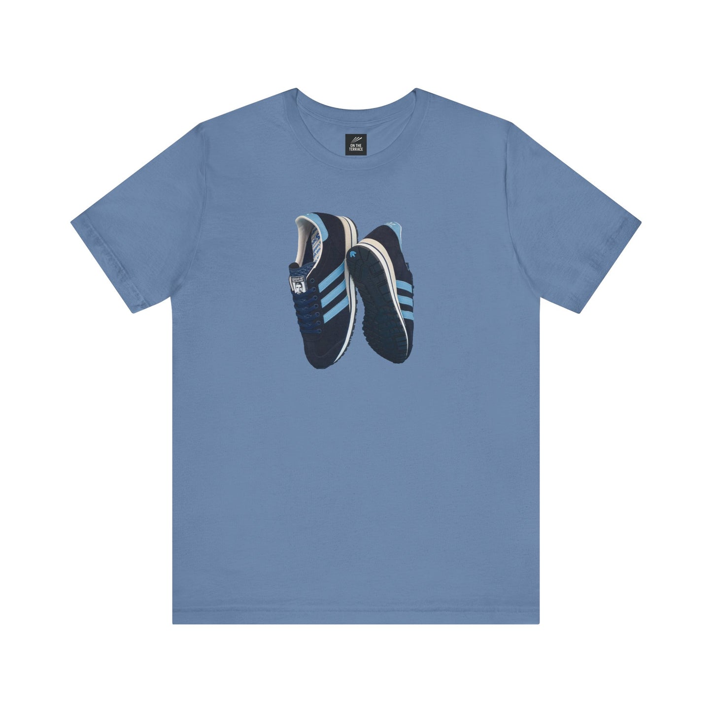 blue t-shirt with graphic of dark blue sneakers featuring light blue stripes and textured soles