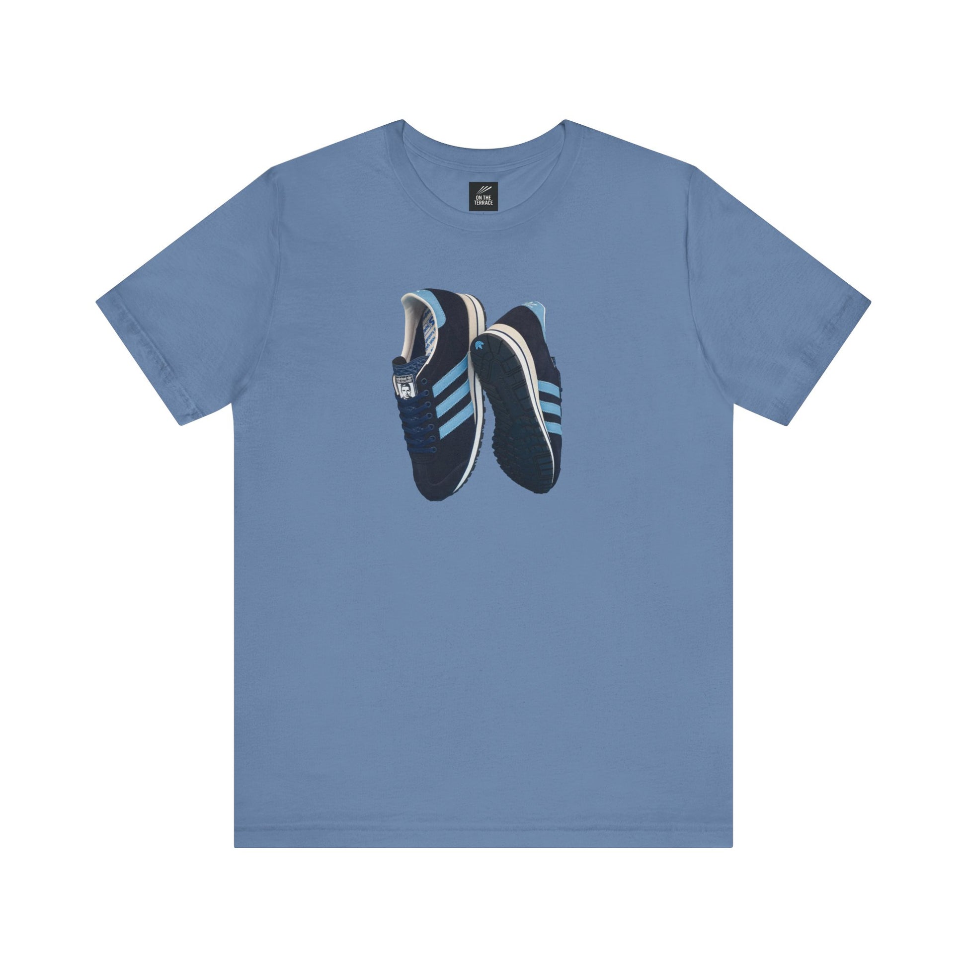blue t-shirt with graphic of dark blue sneakers featuring light blue stripes and textured soles