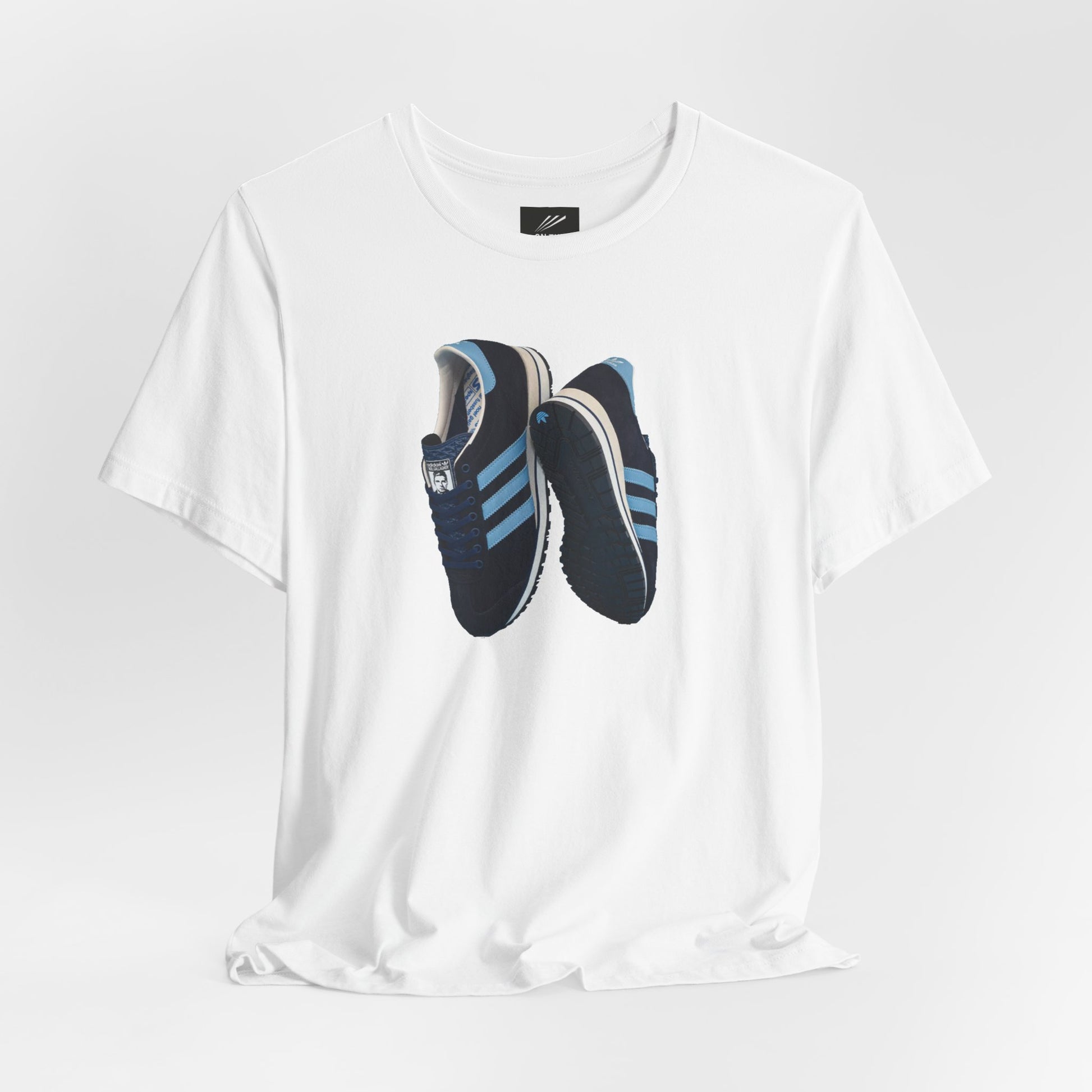 White T-shirt with a print of black and blue Adidas sneakers with blue stripes