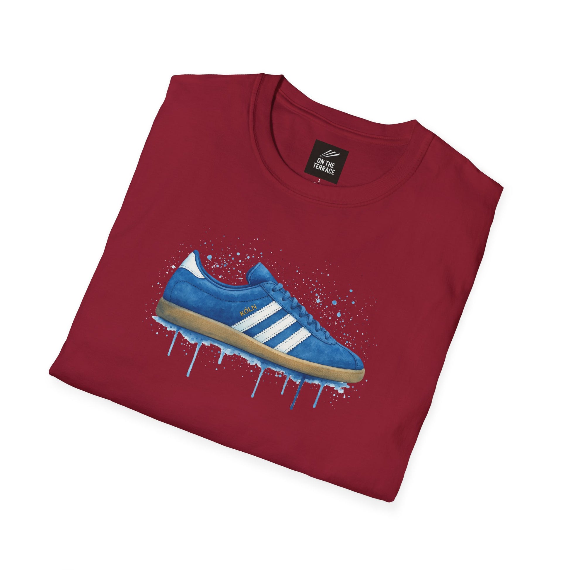 Maroon t-shirt with a blue sneaker graphic featuring white stripes and 'KÖLN' text