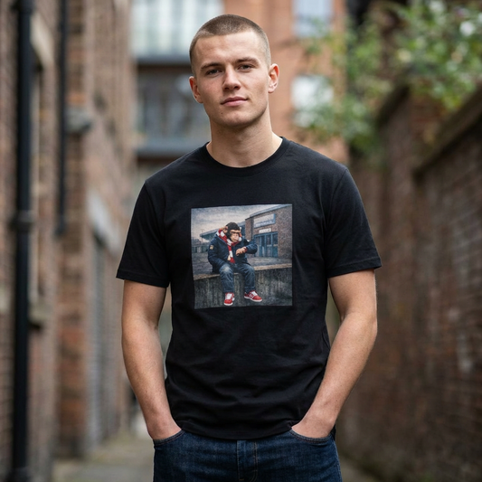 Man wearing a northern monkeys black t-shirt with a graphic design of a person sitting on a bench.