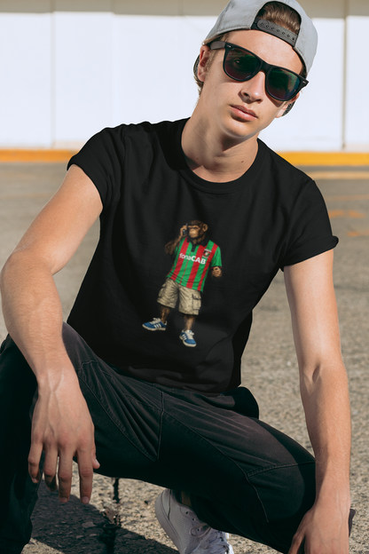Person wearing a Black Glentoran northern monkeys tshirt  with a graphic of a monkey wearing a striped shirt on a white background, sitting outdoors.