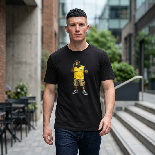 Man wearing a black Spurs t-shirt with a graphic design of a bear in a yellow Spurs jersey, standing outdoors