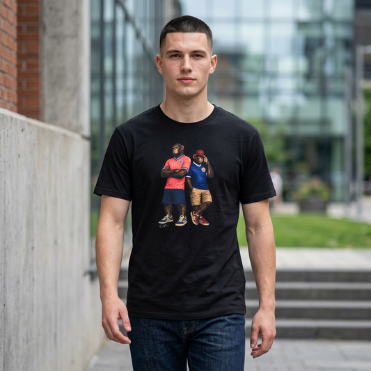 Man wearing a black short-sleeved t-shirt featuring a central graphic of two chimpanzees styled as Scotland national football team fans. The chimpanzee on the left stands with arms crossed, wearing the iconic 1986 pink and yellow striped away jersey with navy shorts. The chimpanzee on the right wears a classic navy blue Scotland home jersey with white trim, khaki cargo shorts, and a maroon bucket hat outdoors