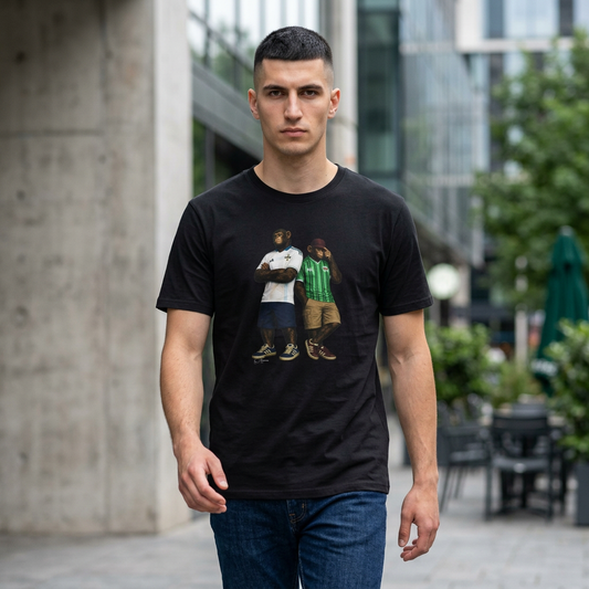 Man wearing a black short-sleeved t-shirt featuring a central graphic of two chimpanzees styled as Northern Ireland national team supporters. The chimpanzee on the left stands with arms crossed, wearing a white away jersey with blue trim and the Northern Ireland crest. The chimpanzee on the right wears the classic green home jersey with vertical stripes, khaki cargo shorts, and a maroon bucket hat outdoors