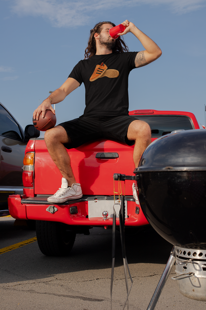 Black t-shirt with orange retro sneaker graphic print showing side and sole view
