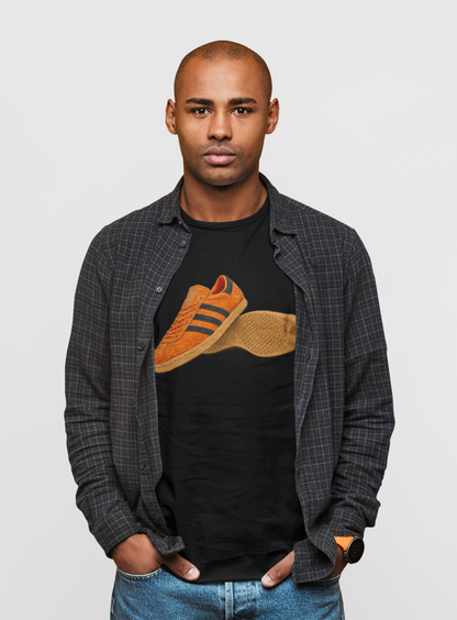 Black t-shirt with orange retro sneaker graphic print showing side and sole view