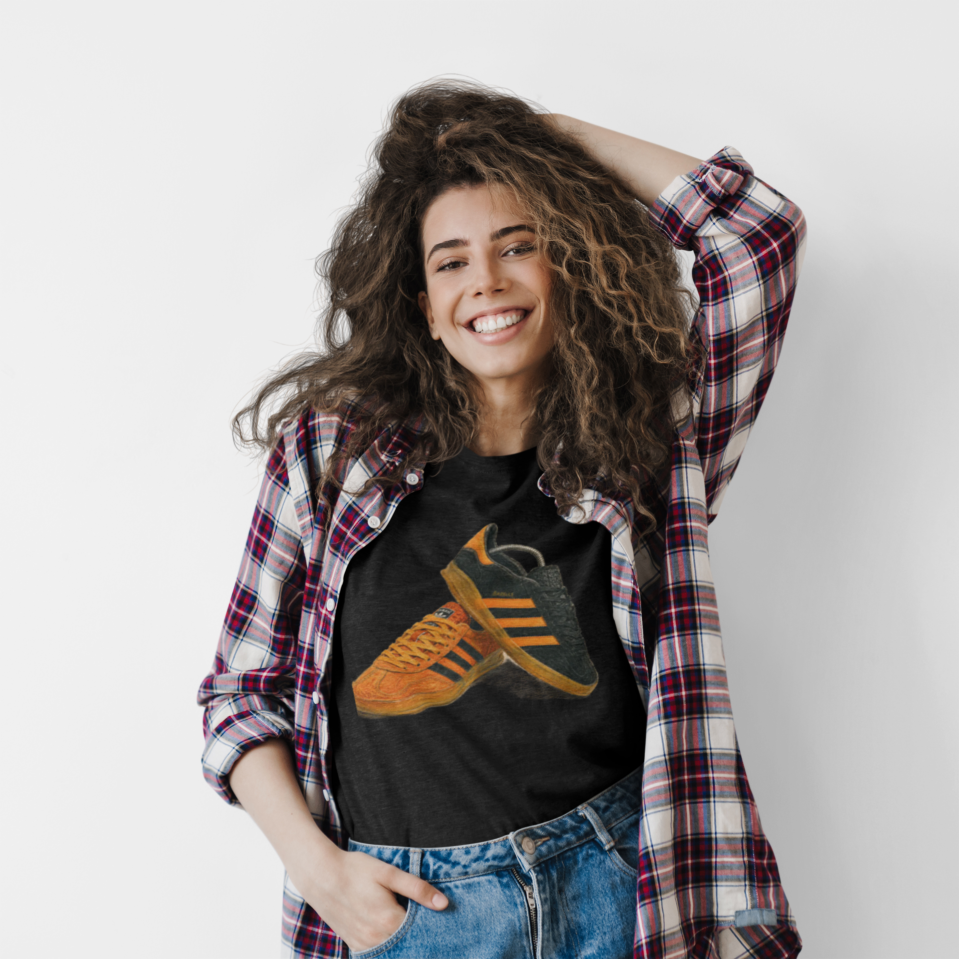 Black t-shirt with orange retro sneaker graphic print showing detailed side and sole view