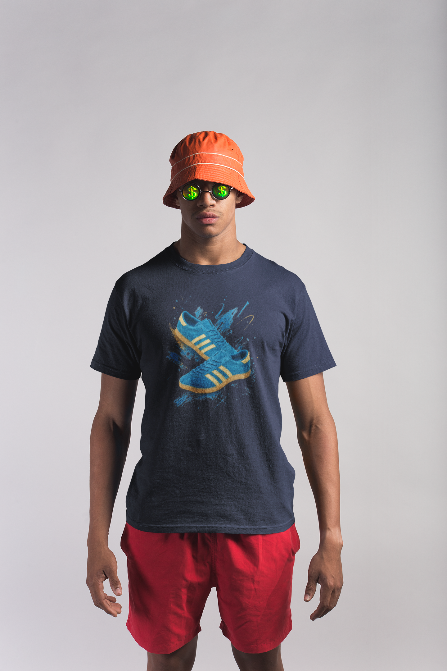Navy blue t-shirt with a printed graphic of a blue suede trainer featuring cream stripes and a gum sole, surrounded by a blue and gold paint splatter design, with an "On The Terrace" logo on the neck label.