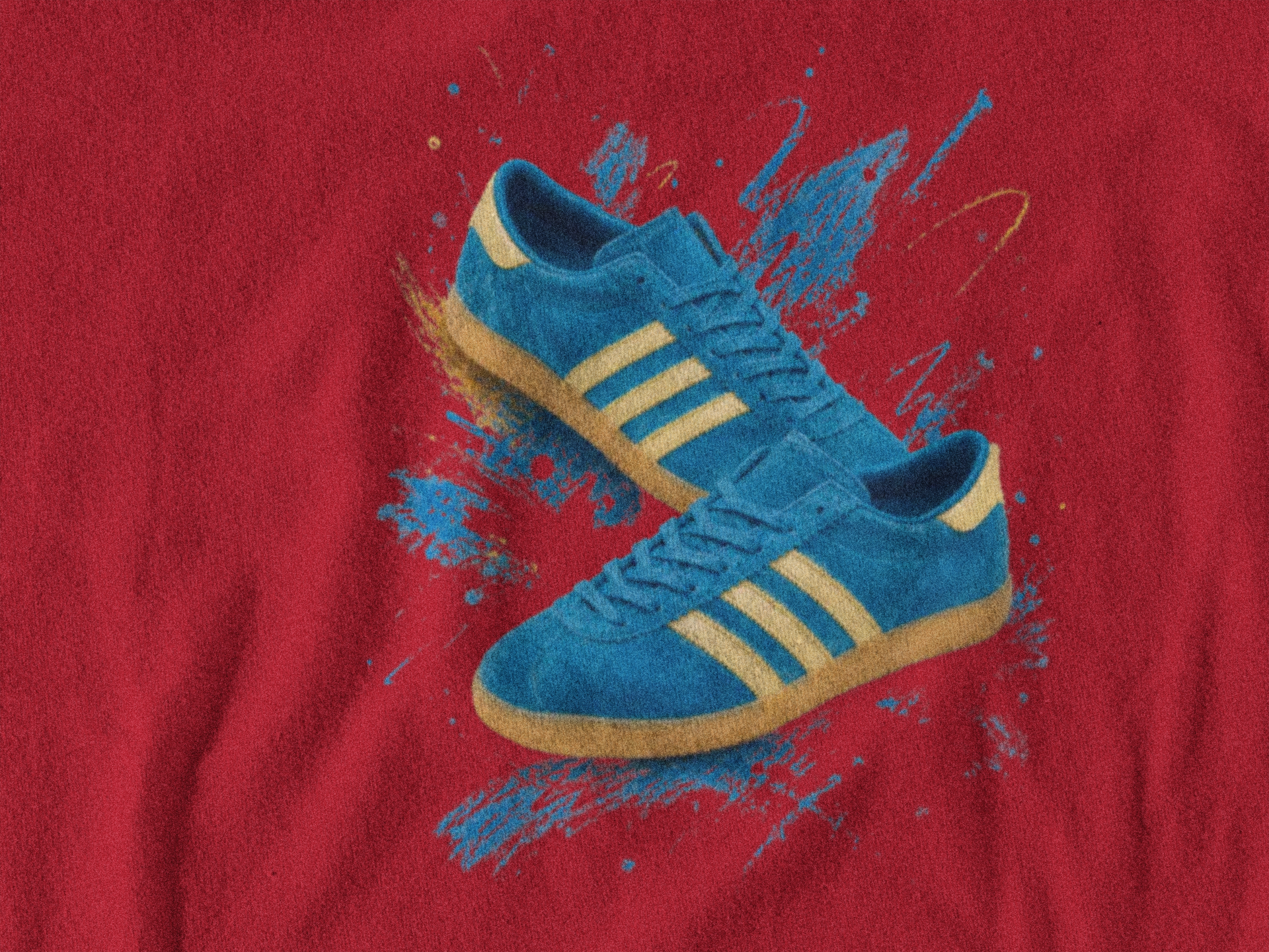 A pair of blue suede sneakers with yellow stripes and gum soles, printed on a red fabric background with blue paint splatters.