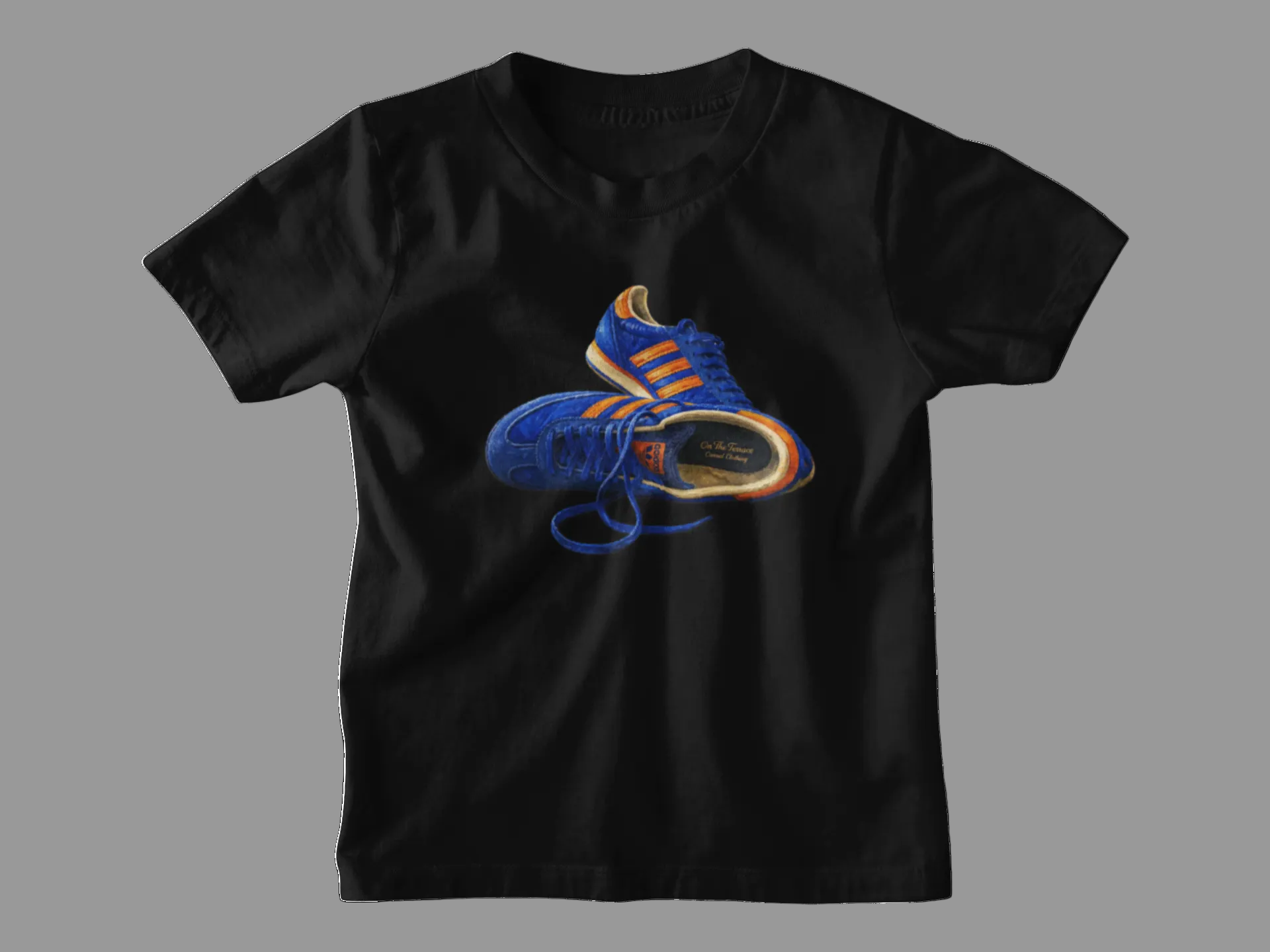 Black t-shirt with hand-illustrated blue and orange retro terrace trainer sneaker graphic print, On The Terrace casual clothing brand
