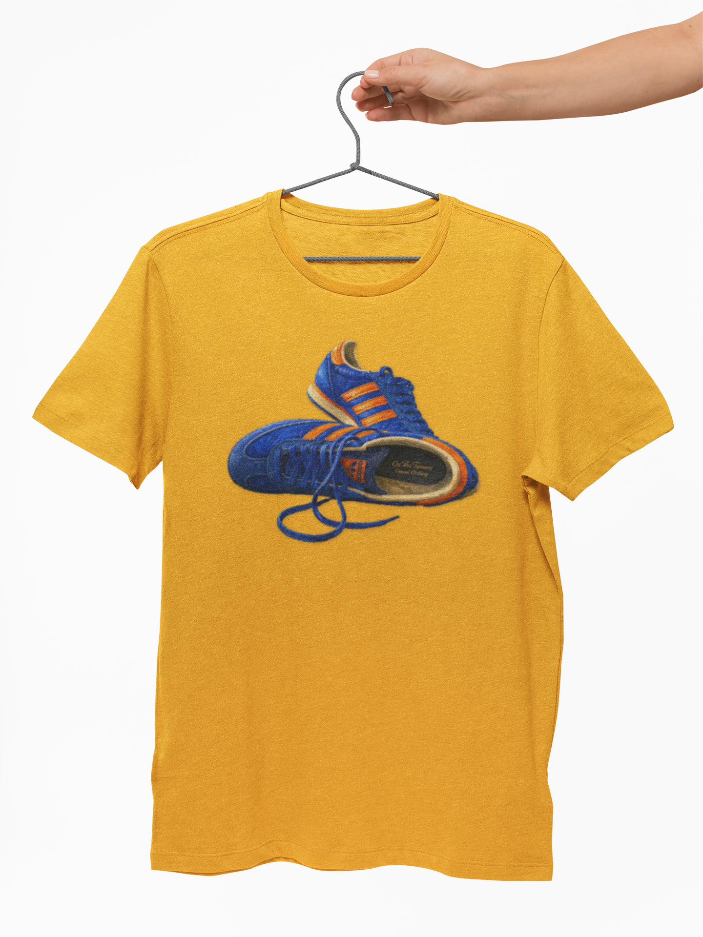 Gold t-shirt with hand-illustrated blue and orange retro terrace trainer sneaker graphic print, On The Terrace casual clothing brand
