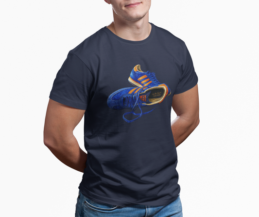 A man wearing a Navy t-shirt with hand-illustrated blue and orange retro terrace trainer sneaker graphic print, On The Terrace casual clothing brand
