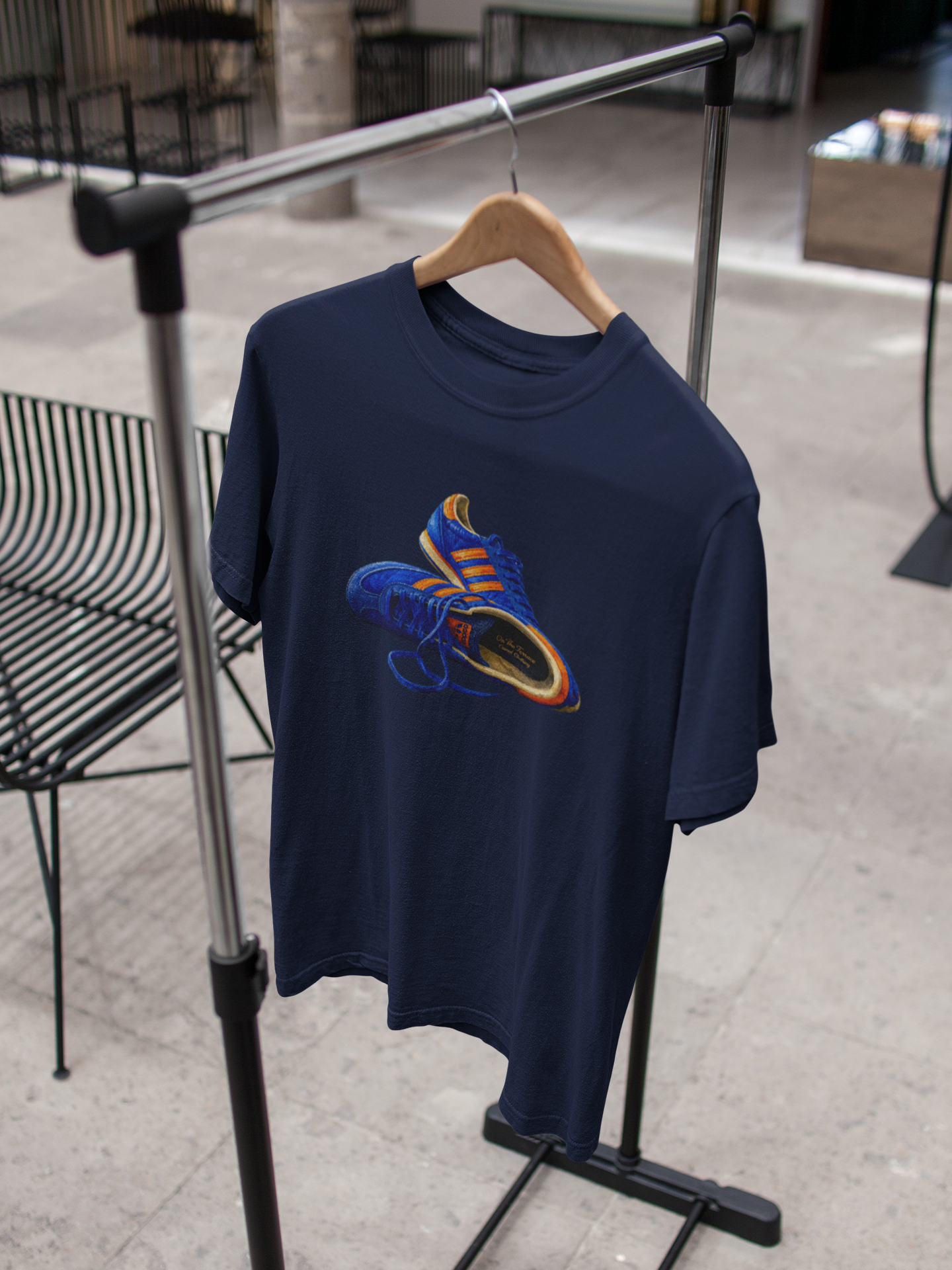 Navy t-shirt with hand-illustrated blue and orange retro terrace trainer sneaker graphic print, On The Terrace casual clothing brand
