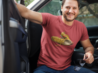 A smiling man sitting in a car wearing a red t-shirt with hand-illustrated yellow, navy and red retro terrace trainer sneaker graphic print, On The Terrace casual clothing brand
