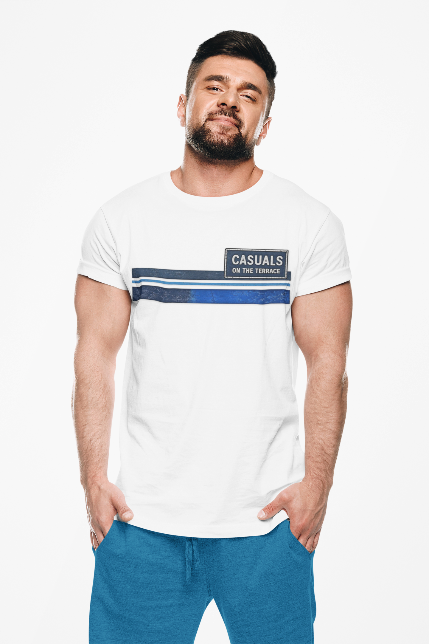 A man wearing a white short-sleeve t-shirt with a navy blue and dark blue horizontal stripe design across the chest, featuring a black rectangular logo patch that reads 'CASUALS ON THE TERRACE'.