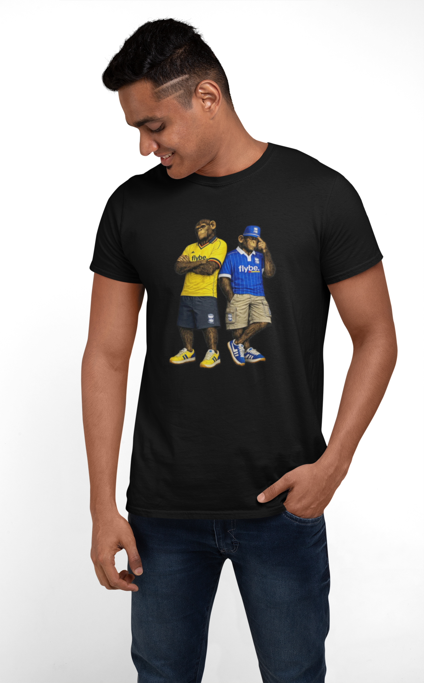 A man wearing a black short-sleeve Birmingham t-shirt with a graphic print of two football players, one in a yellow jersey and one in a blue jersey, paired with dark blue jeans against a plain white background.