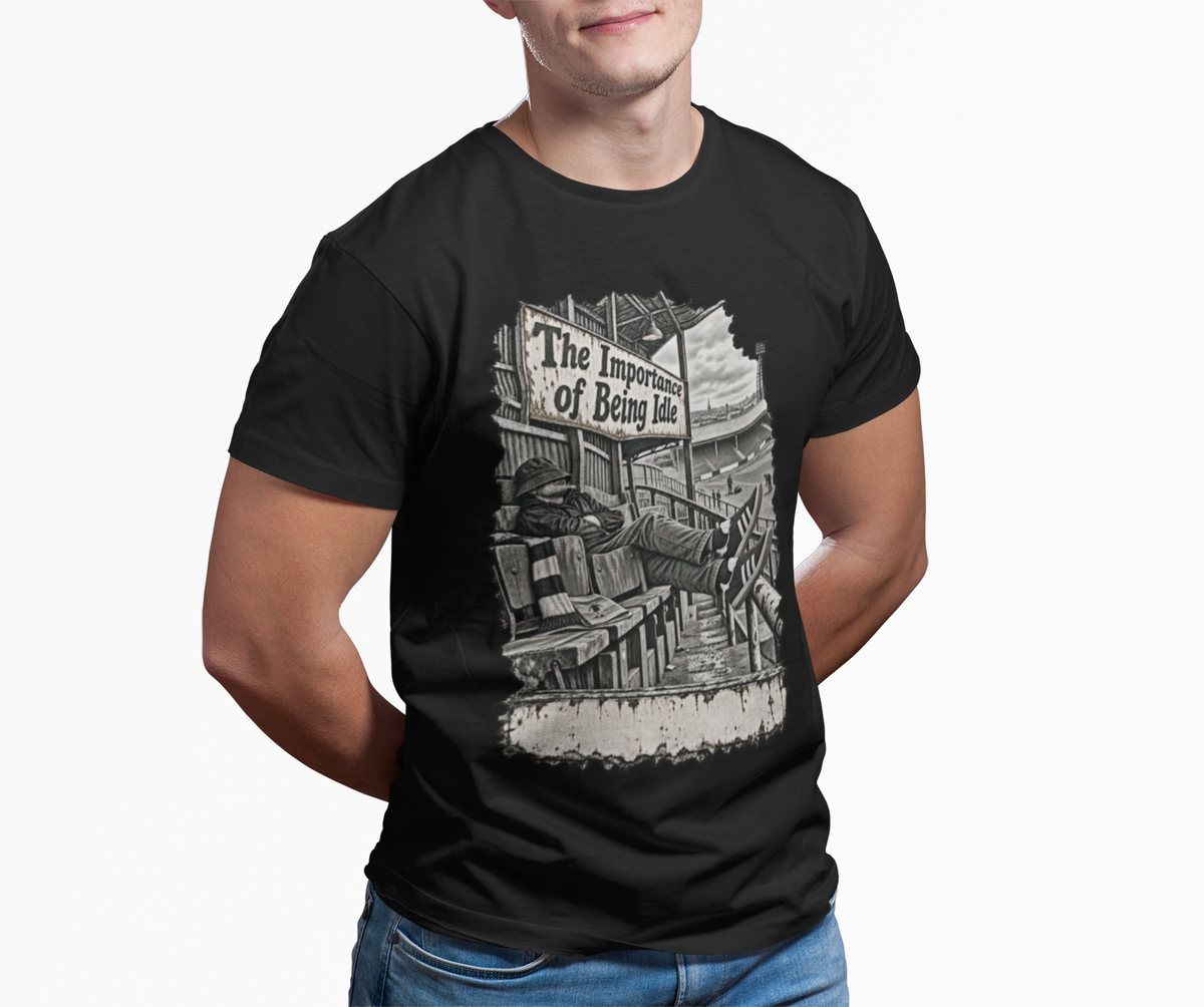 Man wearing black Oasis Importance of Being Idle T-shirt with jeans, terrace casual style