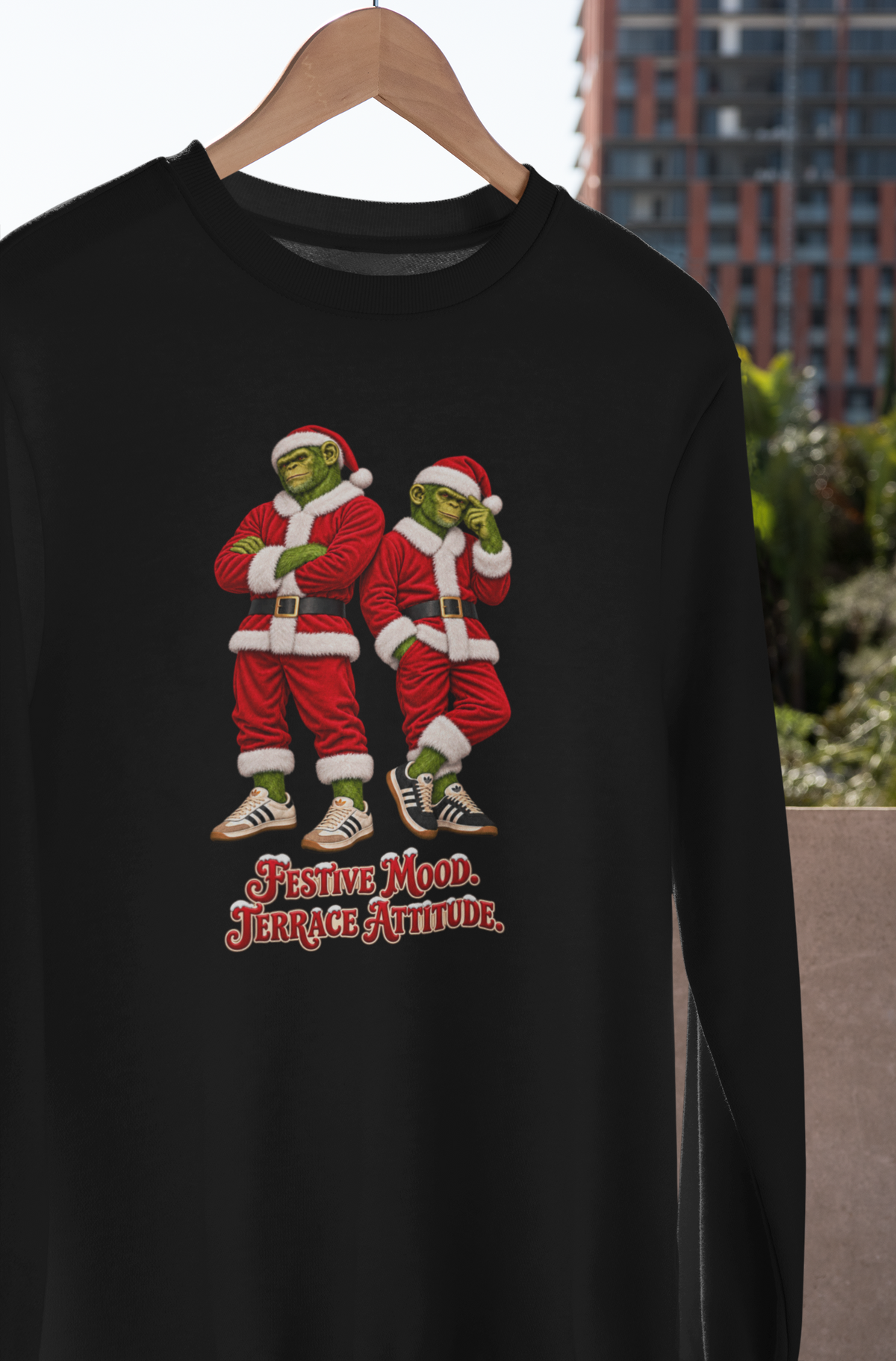 Northern Monkeys Santa chimps Christmas sweatshirt hanging on a wooden hanger