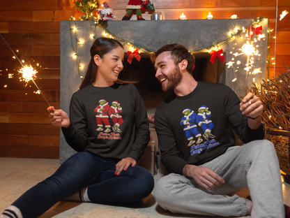Couple sitting by Christmas lights wearing On The Terrace festive football sweatshirts