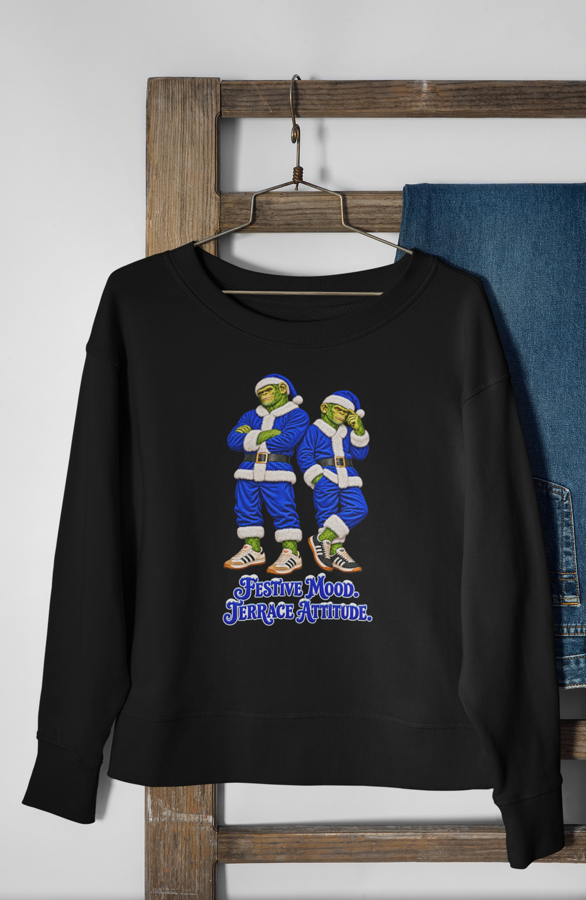 Blue Santa chimps Christmas sweatshirt hanging on a hanger