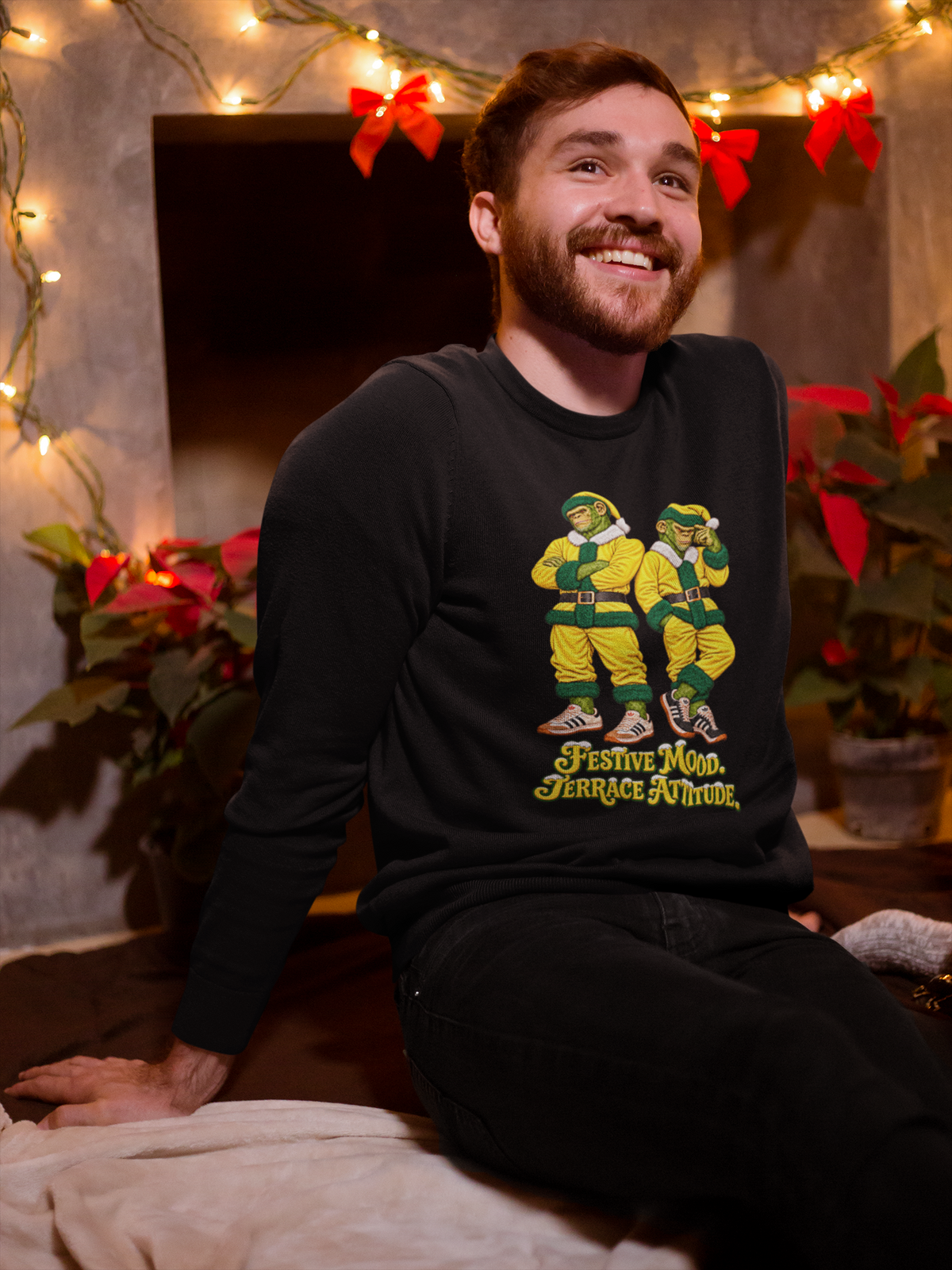 Smiling man by Christmas lights wearing the Norwich yellow Santa chimps sweatshirt