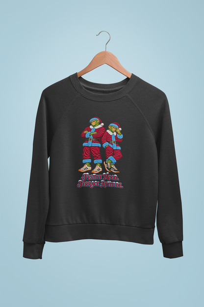 Claret and blue Santa chimps Christmas sweatshirt on a hanger against a blue wall