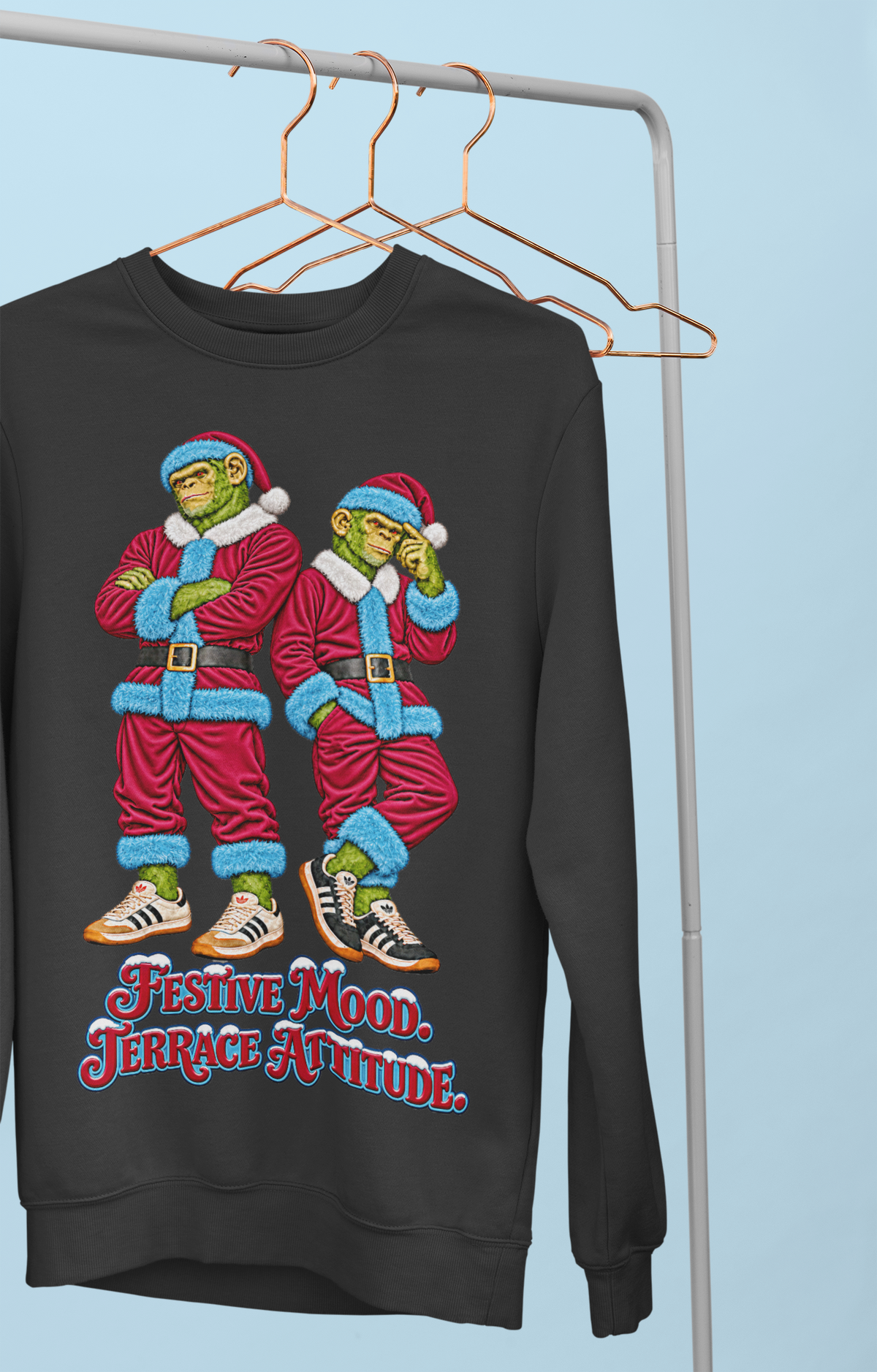 Claret and blue Northern Monkeys Christmas jumper hanging on a clothes rail, Festive Mood Terrace Attitude slogan