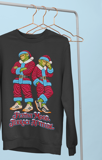 Claret and blue Northern Monkeys Christmas jumper hanging on a clothes rail, Festive Mood Terrace Attitude slogan