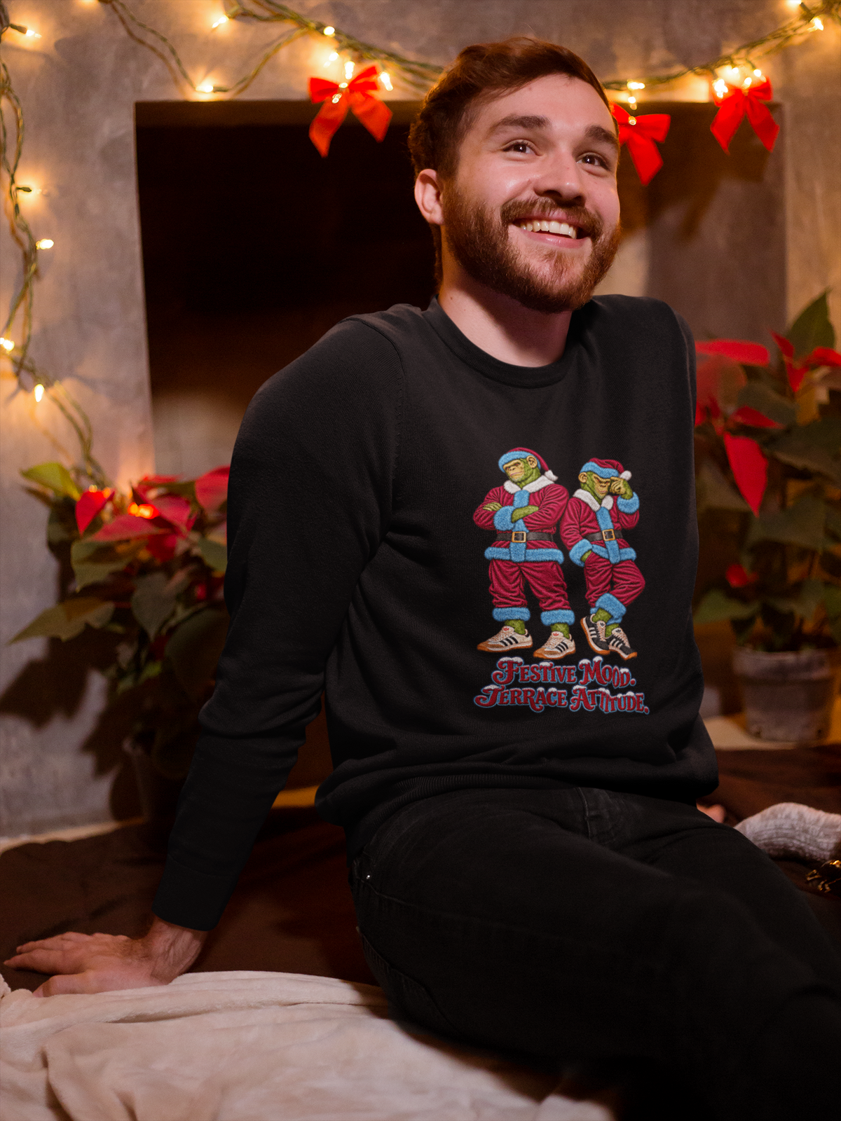 Smiling man by Christmas lights wearing the claret and blue Santa chimps sweatshirt