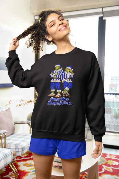 Woman in blue shorts wearing the black blue and white striped Northern Monkeys Christmas sweatshirt