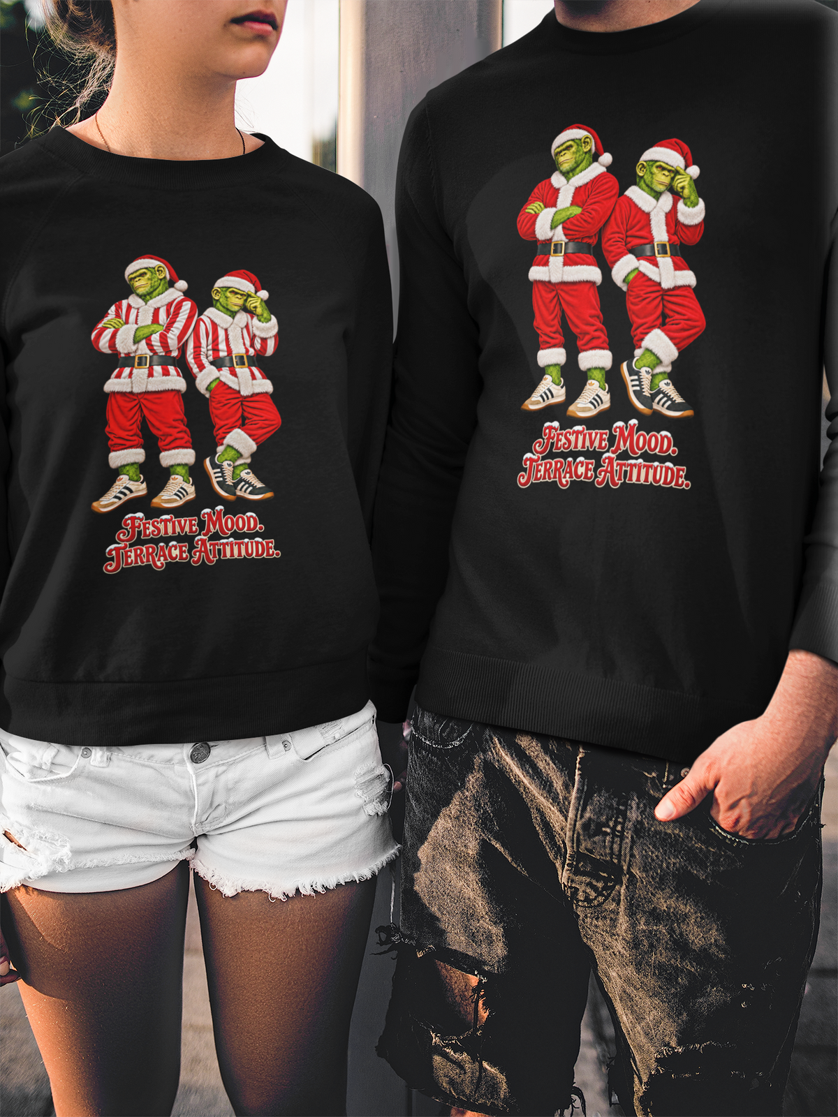 Couple wearing the red and white stripe and classic red Northern Monkeys Christmas jumpers