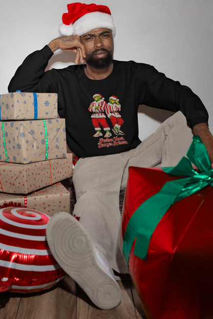 Man in a Santa hat by wrapped presents wearing the red and white stripe Northern Monkeys jumper