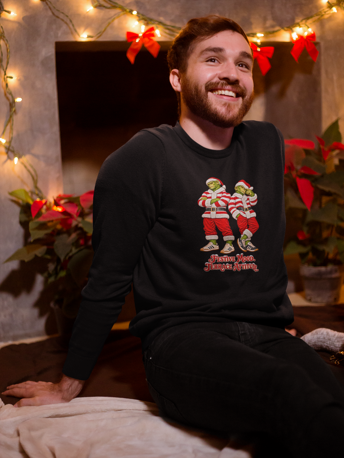 Smiling man by Christmas lights wearing the red and white hooped Northern Monkeys Christmas jumper, Doncaster Rovers and Hamilton colours