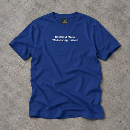 Royal blue embroidered Sheffield Made Wednesday Raised tee laid flat on concrete