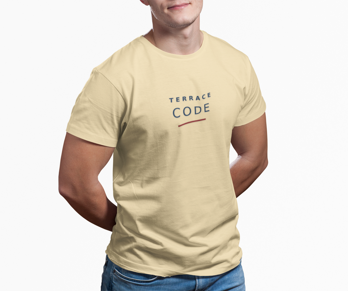 Man wearing the pale yellow Terrace Code football casuals T-shirt with jeans