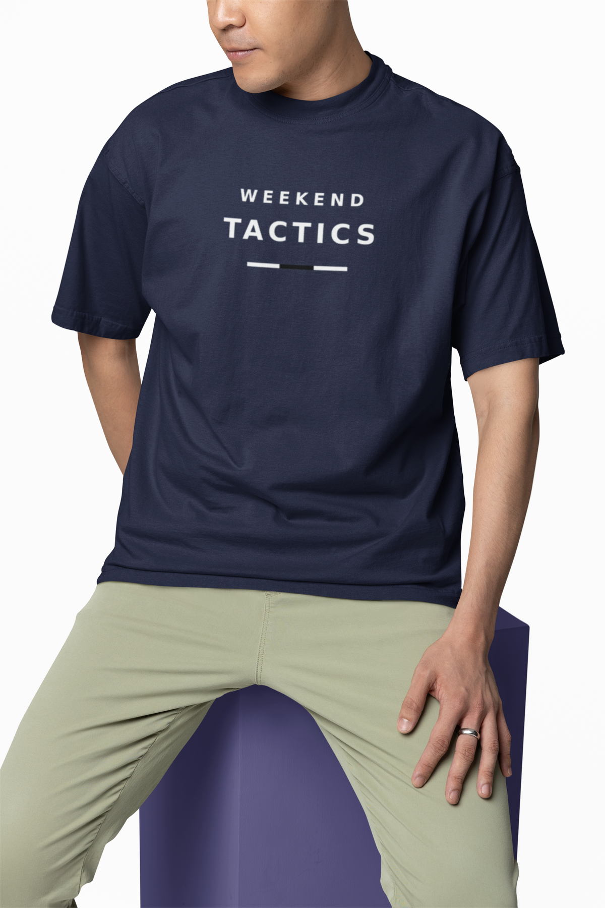 Man wearing the navy Weekend Tactics T-shirt with olive chinos