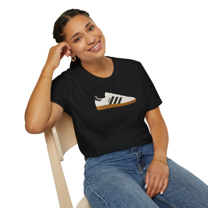 Smiling woman wearing black t-shirt with white and black sneaker graphic sitting on wooden chair