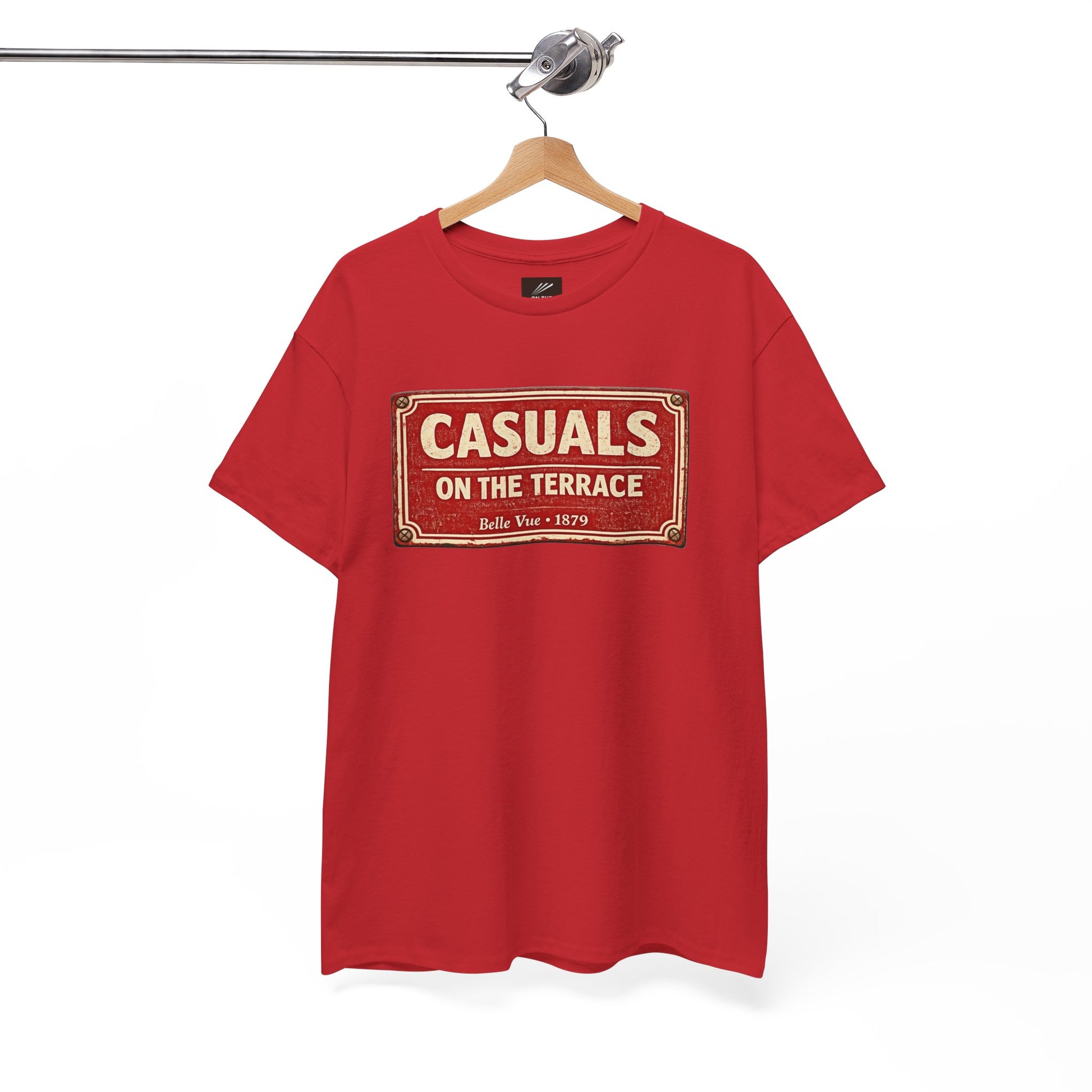 a red DRFC t-shirt flat lay featuring a central vintage red and white street sign graphic reading "CASUALS ON THE TERRACE" with "Belle Vue • 1879" printed below, and an inner neck label for On The Terrace. on a hanger against a white background