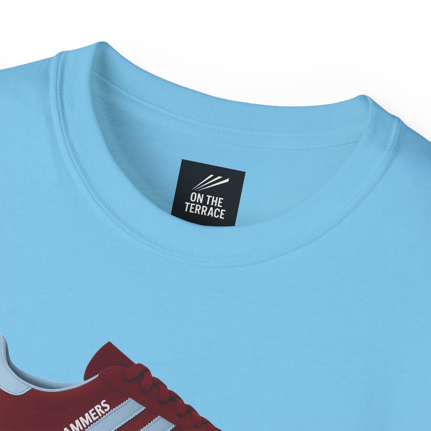Light blue crew neck T-shirt with on the terrace brand tag and red sneaker graphic print