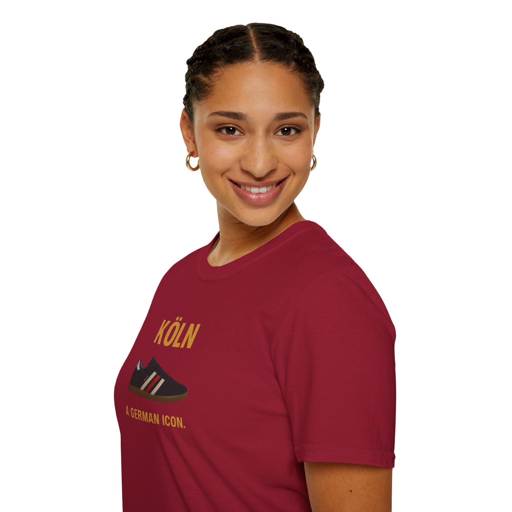 Smiling woman with braided hair wearing a burgundy t-shirt with Cologne sneaker and text Köln A German icon
