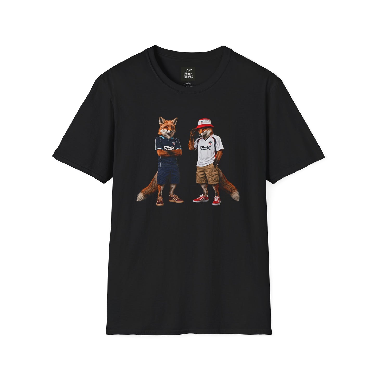 A black graphic t-shirt laid flat, featuring a central design by On The Terrace for Bolton fans. The graphic showcases two anthropomorphic English foxes dressed in vintage Rbk Bolton-inspired football kits. The fox on the left wears the dark blue retro away jersey with arms crossed, while the fox on the right sports the classic white home shirt, a red and white bucket hat, and cargo shorts. The inner neck of the tee features the official "On The Terrace" brand logo
